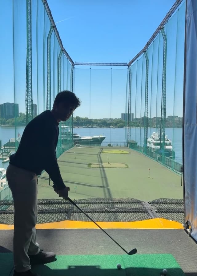 Talking to golfers at the driving range